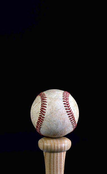 Baseball Time. Baseball on wooden bat with room for your type. baseball bat home run baseball wood stock pictures, royalty-free photos & images