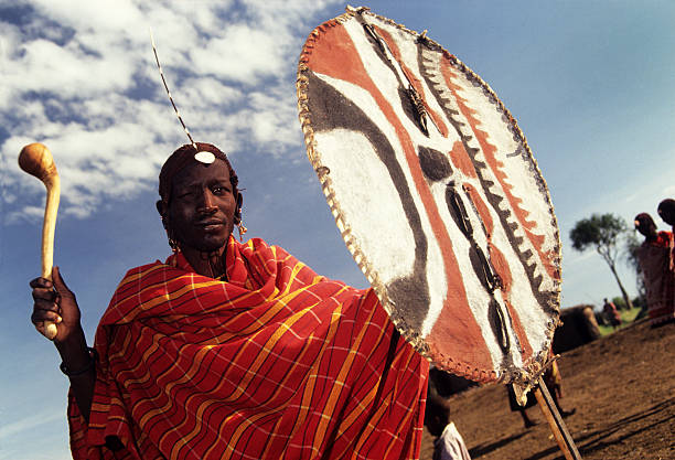 Masai Mara, Kenya - March  20, 1995: Masai tribesmen with decorated shield and rungu, Masai Mara Game Reserve, Kenya