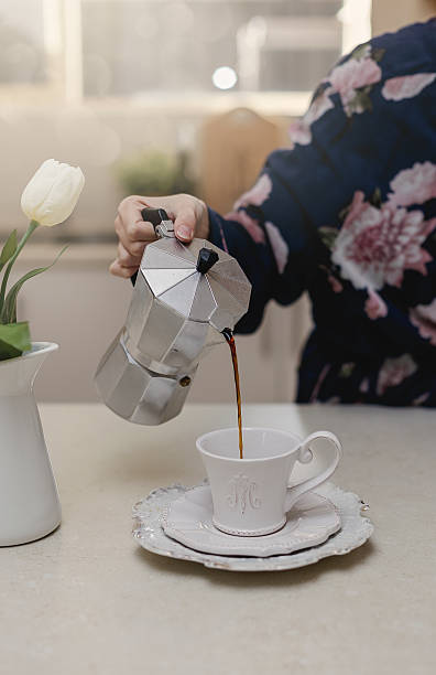 istock Female hand pouring coffee in a cup 579737694