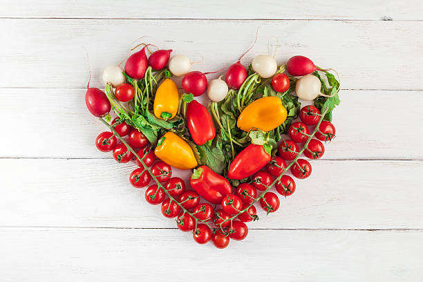 istock Fresh vegetables in a heart shape, top view, flat lay 579738448
