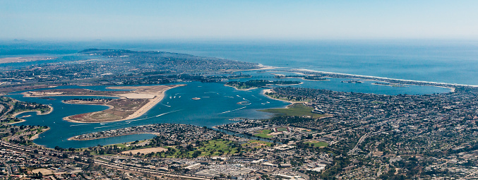 An aerial view of Mission Bay in San Diego.  The communities of Pacific Beach, Mission Beach, and Ocean Beach are visible as is Sea World.