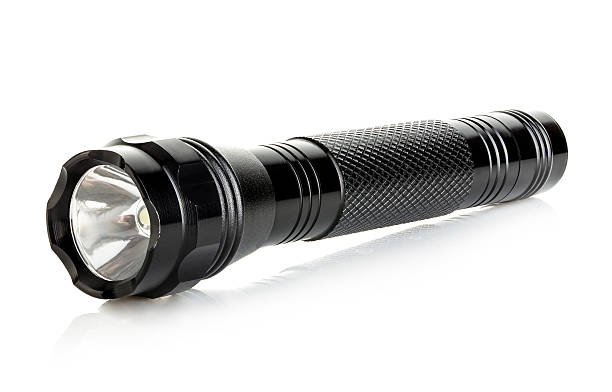 istock Black metallic flashlight close-up isolated on a white background. 579740268