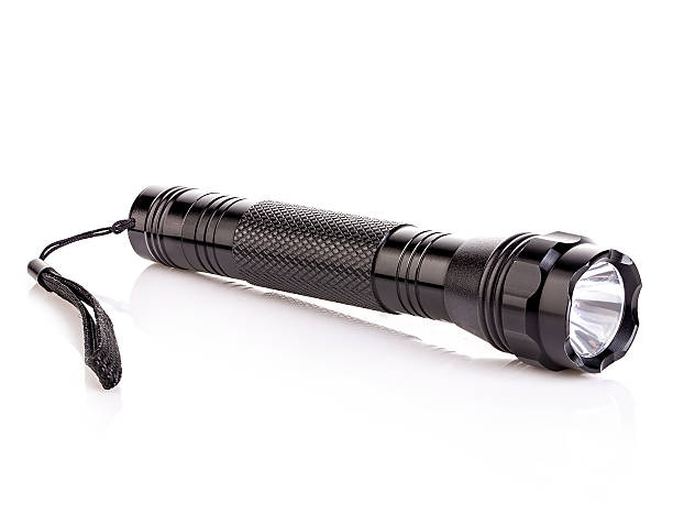 istock Black metallic flashlight close-up isolated on a white background. 579740298