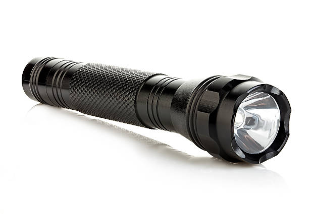 istock Black metallic flashlight close-up isolated on a white background. 579740304