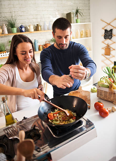 istock young couple cooking together 579740928
