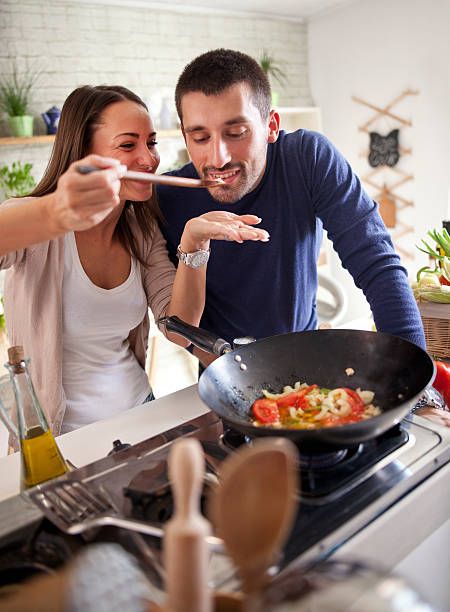 istock young happy attractive couple at home kitchen tasting 579741752