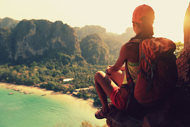 istock young woman hiker enjoy the view on mountain peak cliff 579742608