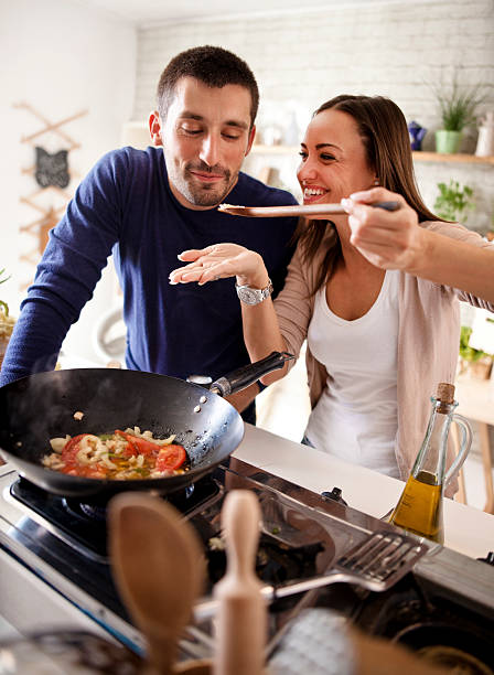 istock young happy attractive couple at home kitchen tasting 579743914