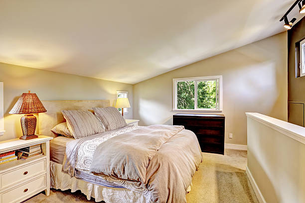 istock Nice upstairs bedroom with king size bed and vaulted ceiling. 579744318