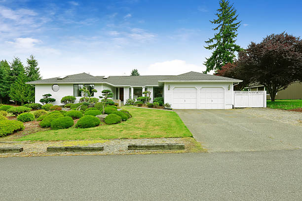 istock White one story house with nice landscape design. 579745474