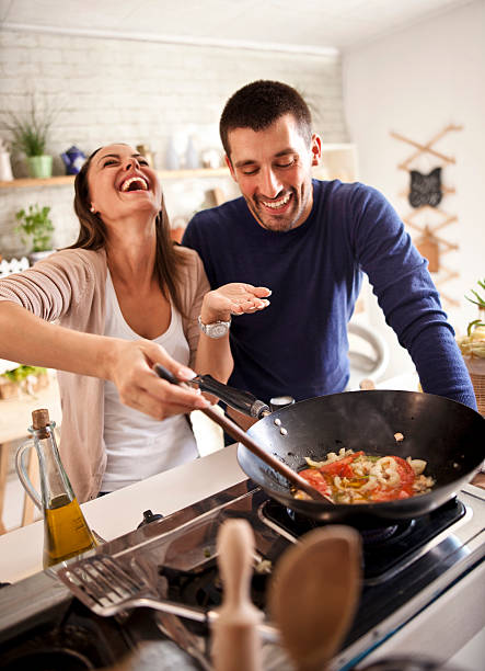 istock young happy attractive couple at home kitchen tasting 579745878