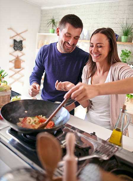 istock young happy attractive couple at home kitchen tasting 579747020