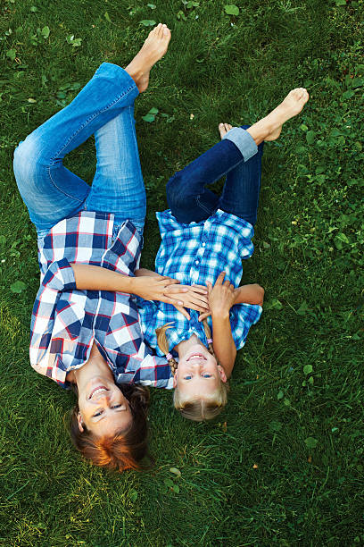 istock Happy mother and child laying on meadow 579749270