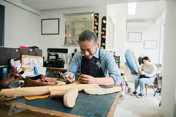 istock Shoe deisgners working at the factory 579751744