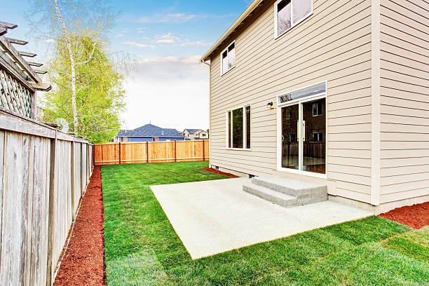 istock House fenced back yard exterior  with well kept lawn 579752838