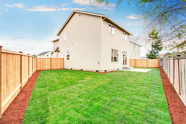 istock House fenced back yard exterior  with well kept lawn 579752952