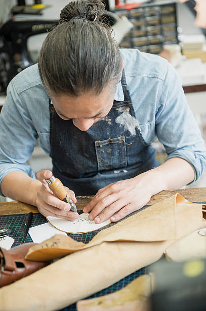 istock Shoe deisgners working at the factory 579753560