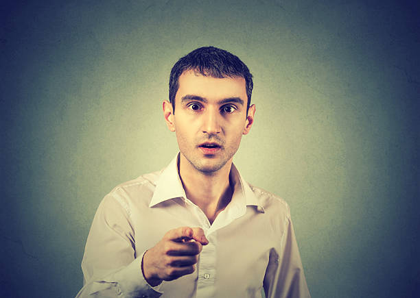 istock Surprised stunned man pointing finger at you camera 579754050
