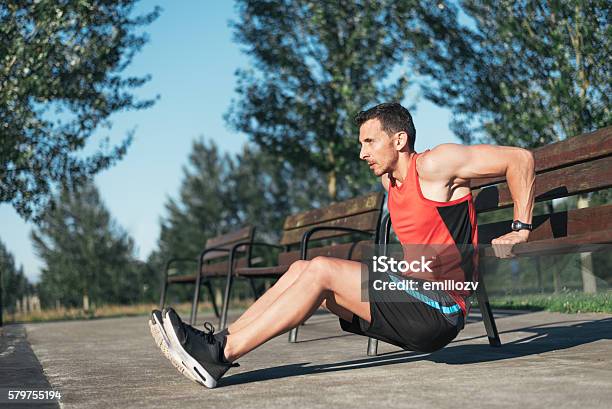 Fitness Man Doing Bench Triceps Dips Outdoors While Working Out Stock Photo - Download Image Now