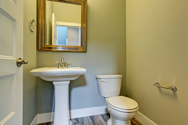 istock Small bathroom interior with washbasin stand, toilet and framed mirror 579756788