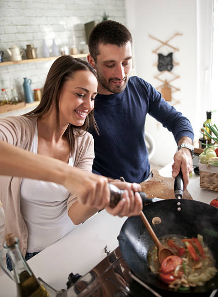 istock young happy attractive couple at home kitchen tasting 579759446