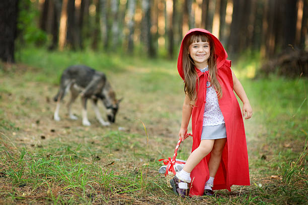 lobo persigue a la chica. cuento de hadas "caperucita roja" - fairy child outdoors fairy tale fotografías e imágenes de stock