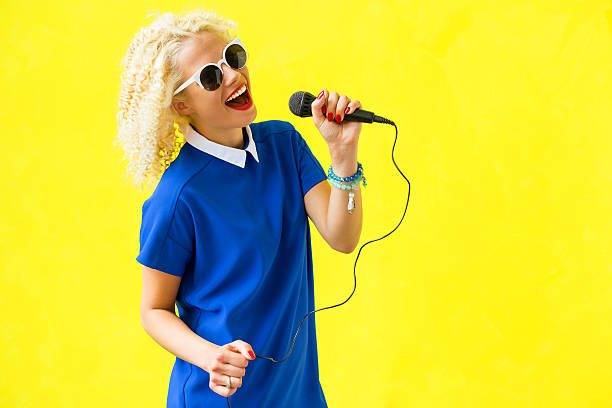 istock Woman singing in microphone 579761796