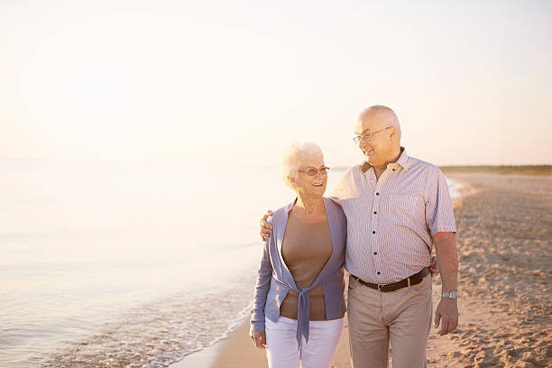 istock Senior couple walking on the summer beach 579762196