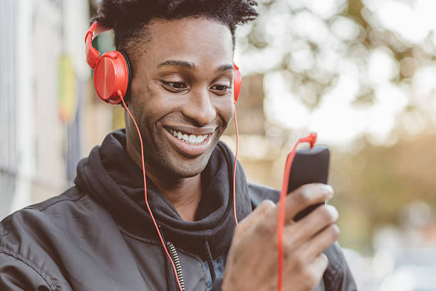 istock Afro american guy using smart phone on the street 579762278