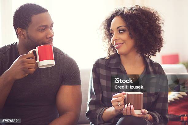 Afro American Couple Drinking Coffee At Home Stock Photo - Download Image Now - Men, Mug, Winter
