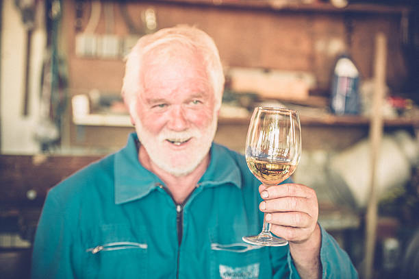 istock Senior Man with Beard Drinking Glass of White Wine 579763574
