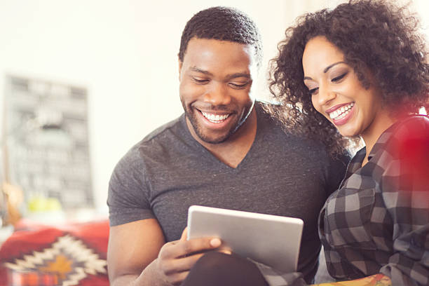 istock Afro american couple using a digital tablet at home 579763730