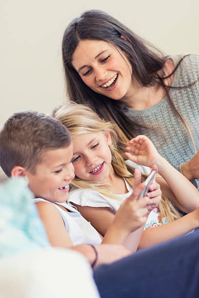 istock Mother and kids gaming together 579764722