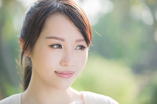 young woman student smile to you. nature green background