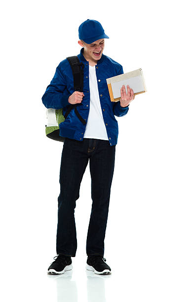 istock Cheerful male student holding books 579766424