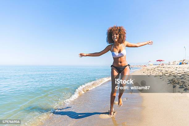 Young Black Woman Having Fun At Seaside Stock Photo - Download Image Now - Beach, Women, Black Color