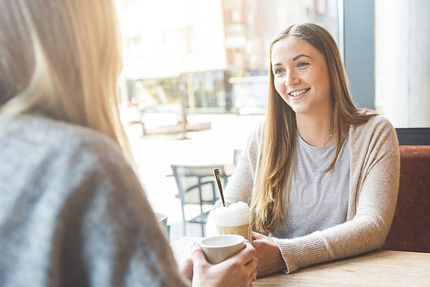 istock Two beautiful young women in a cafe 579767646