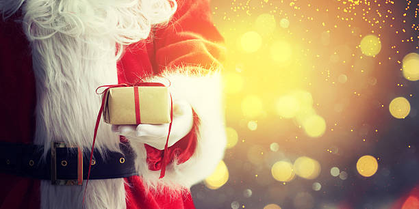 istock Santa Claus gloved hands holding giftbox 579767810