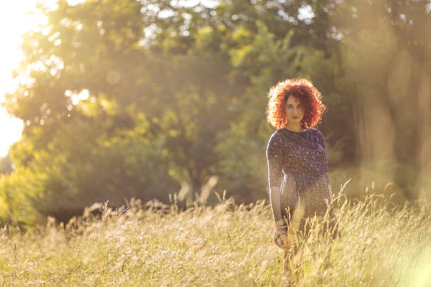 istock Attractive young redhead woman in Summer scenery 579767900