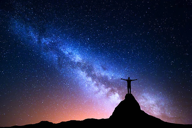 istock Silhouette of a standing man on the mountain peak 579769040
