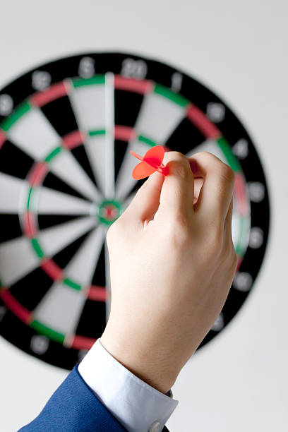 istock Businessman holding a dart aiming at the target 579770524