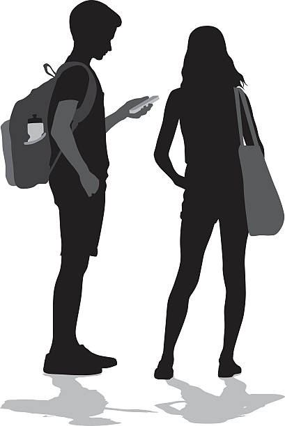 Teenagers Socializing In Person And With Technology A vector silhouette illustration of two preteens standing together with the young boy looking at his cell phone.  A young girl stands beside him. junior high age stock illustrations