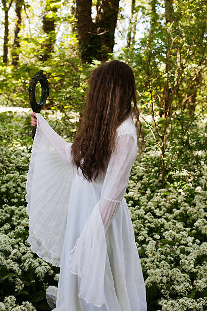 istock Beautiful young woman looking into a mirror 579771228