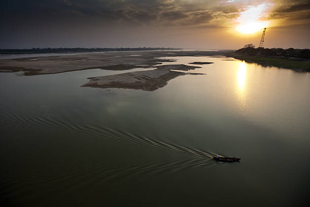 istock Burmese fishingboat at dusk 579773704