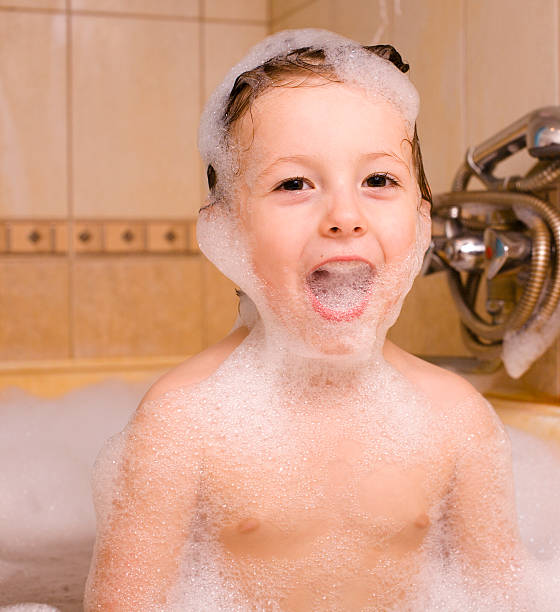 istock little cute boy in bathroom with bubbles close up smiling 579775790