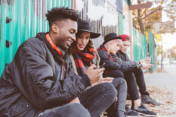 istock Multi ethnic group of hipsters outdoors usping phones 579776098