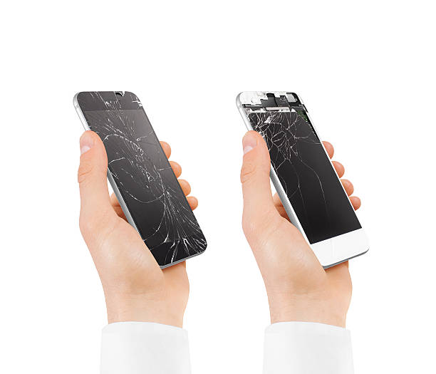 istock Set of hands holding broken phones with smashed touch screen. 579776242