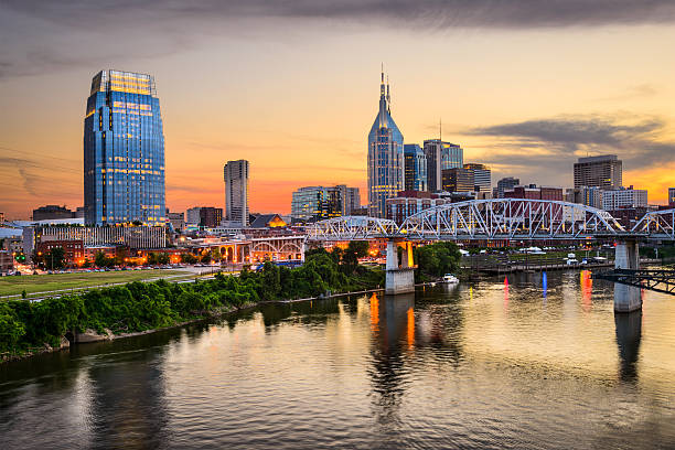Nashville, Tennessee Skyline Nashville, Tennessee, USA downtown skyline on the Cumberland River. nashville tennessee bridge stock pictures, royalty-free photos & images