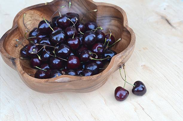 istock Cherry Cherry in a wooden plate 579778398