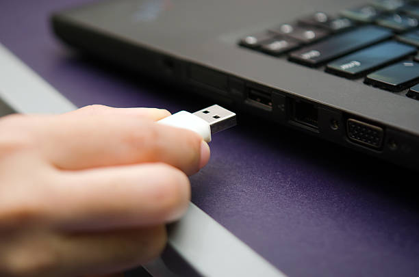 istock USB stick or USB thumb drive plug in to laptop 579778452